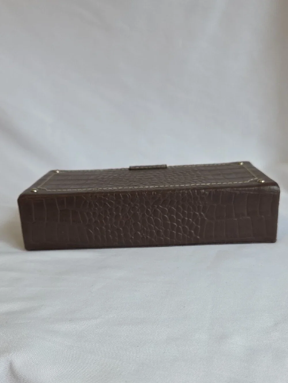 A brown crocodile-embossed faux leather jewelry and watch display box